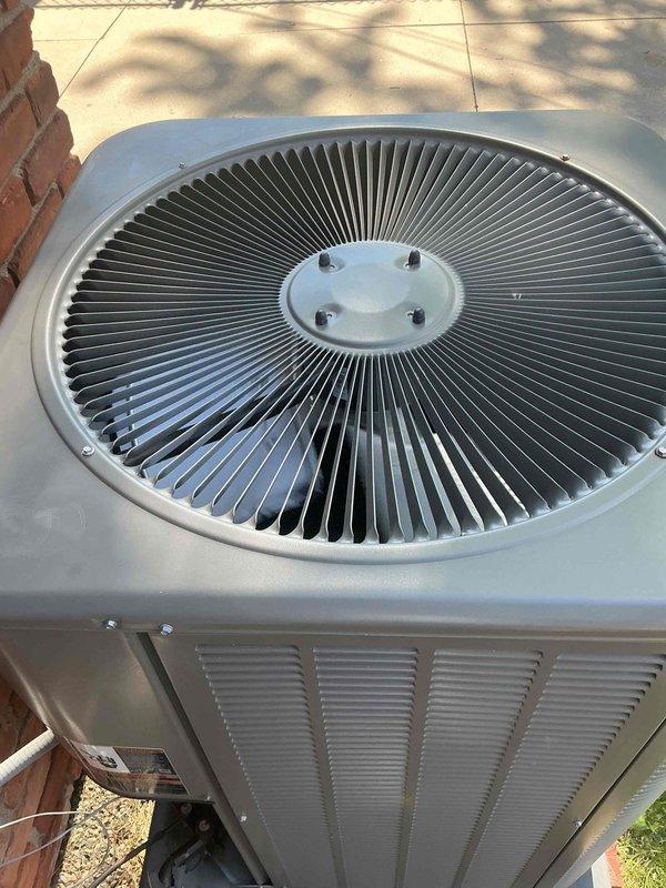 Completed comprehensive tune-up service on a 4-year-old residential air conditioning system with outdoor condenser unit and basement-located air handler. Performed standard maintenance procedures including inspection of condenser fan assembly, verification of proper airflow through louvered panels, assessment of unit housing integrity, and confirmation of secure mounting on concrete pad. System found to be in good operating condition with no significant wear, corrosion, or performance issues identified during inspection.