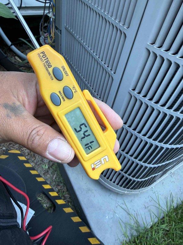 Completed comprehensive Gold AC inspection on outdoor condensing unit. Performed diagnostic testing using digital multimeter and temperature measurements, recording supply air temperature of 54°F and system voltage of 246.6V with amperage draw of 00.10A. Inspected 10-year-old evaporator coil located in basement, verified proper operation of condenser fan motor, and assessed overall system performance. All components found operating within normal parameters with no immediate service needs identified at this time.