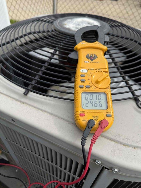 Completed comprehensive Gold AC inspection on outdoor condensing unit. Performed diagnostic testing using digital multimeter and temperature measurements, recording supply air temperature of 54°F and system voltage of 246.6V with amperage draw of 00.10A. Inspected 10-year-old evaporator coil located in basement, verified proper operation of condenser fan motor, and assessed overall system performance. All components found operating within normal parameters with no immediate service needs identified at this time.