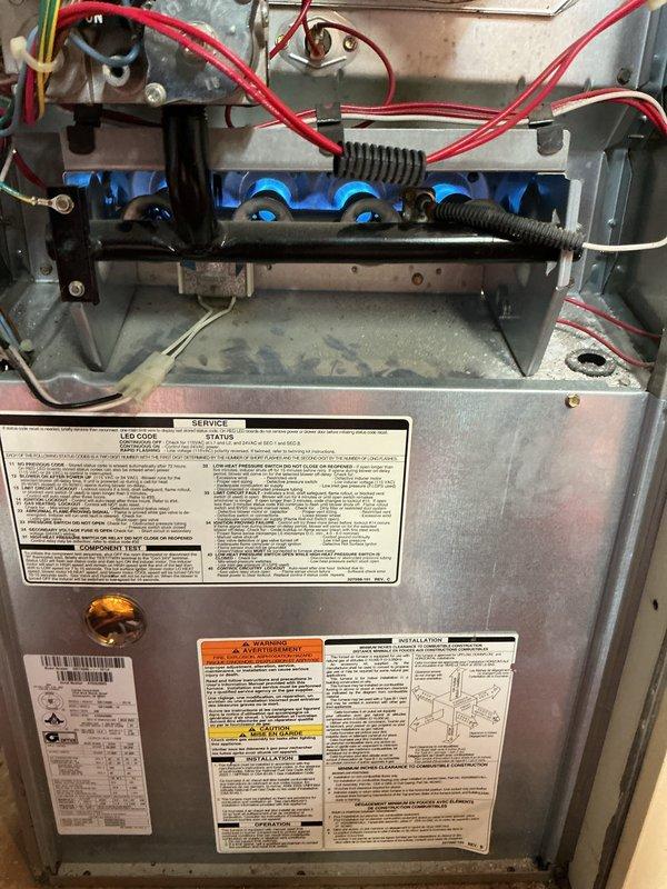 Completed comprehensive Gold AC Inspection on residential HVAC system with furnace and air conditioning units, both over 10 years old with air handler located in basement. Performed thorough visual inspection of gas furnace including burner assembly, ignition components, heat exchanger, and electrical connections. Inspected A.O. Smith 50-gallon natural gas water heater (Model GCG-50 400, manufactured June 2019) and verified compliance labeling and operational status. Documented equipment condition through photographic records showing furnace interior components, blue metallic burner assembly with flame ports, safety controls, and all manufacturer specification labels. All equipment confirmed operational at time of inspection.