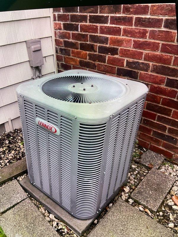 Completed comprehensive Gold Plan AC tune-up and inspection on 20-year-old Lennox condensing unit located at rear of residence. Performed full system diagnostics including refrigerant level check, electrical component testing, capacitor analysis, contactor inspection, and thermostat calibration. Cleaned condenser coils, cleared debris from unit perimeter, verified proper airflow through top-mounted fan assembly, and confirmed all safety controls functioning within manufacturer specifications. Inspected exterior cabinet condition, verified secure mounting on concrete pad, and ensured adequate clearance from surrounding structures. Unit operating efficiently with no immediate repairs required at this time; however, given the system age, recommended monitoring performance closely and considering replacement planning within the next few years to avoid unexpected failures during peak cooling season.