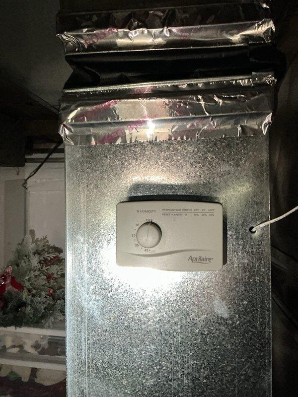 Completed routine Gold AC tune-up on 6-year-old outdoor condensing unit. Performed standard maintenance protocol including refrigerant charge verification, electrical connection inspection, condenser coil cleaning, and operational testing. During interior inspection, observed significant condensation and frost accumulation on basement-mounted Aprilaire humidifier unit and surrounding ductwork, indicating potential drainage obstruction or excessive humidity settings. Inspected humidifier control panel and mounting connections; noted moisture buildup on black ductwork and metal surfaces. Verified air handler operation and documented conditions with photos for reference. System currently operational with all safety controls functioning properly. Recommend scheduling follow-up service to address humidifier drainage issue and adjust humidity settings to prevent continued moisture accumulation on equipment surfaces.