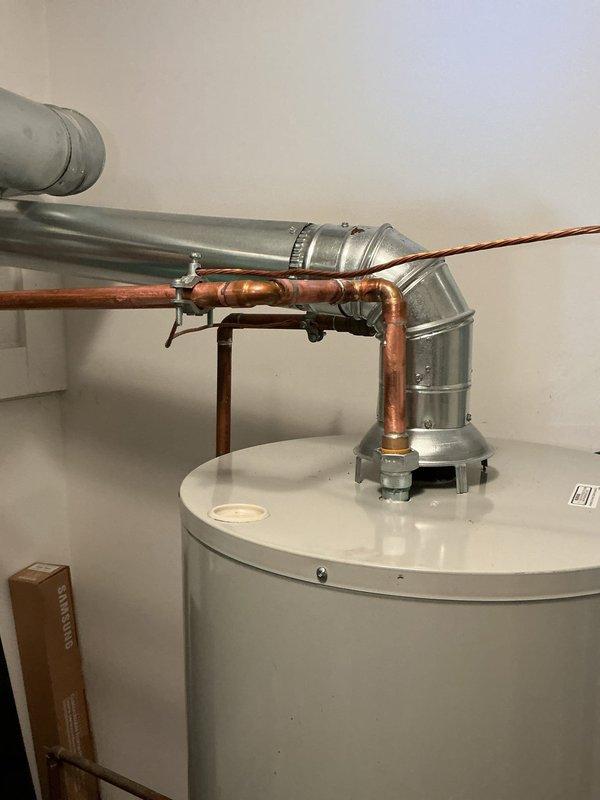 Completed mechanical installation of 50-gallon standard residential water heater including all plumbing connections, venting, and gas line hookup. Reconnected copper water supply lines, installed proper venting with galvanized ductwork, and ensured all connections meet code requirements for safe operation.