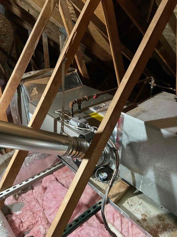 Completed full-day installation of 70,000 BTU furnace system in attic space, including S40 coil, drain pan, and new supply ductwork. Installed all components on attic joists with proper support brackets, routed condensate lines and electrical connections, and completed first-floor ductwork modifications. Mechanical and electrical permits obtained, system reconnected and tested for proper operation, with utility rebate documentation submitted.