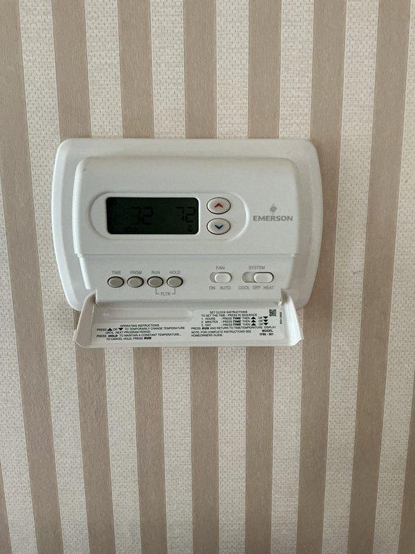 Completed comprehensive Gold AC inspection on single residential cooling system with air handler located in basement. Verified system operational status, documented thermostat functionality with Emerson digital control unit, and inspected basement mechanical room housing HVAC equipment. All components found operating within normal parameters, with equipment age under 10 years and system responding appropriately to thermostat commands.