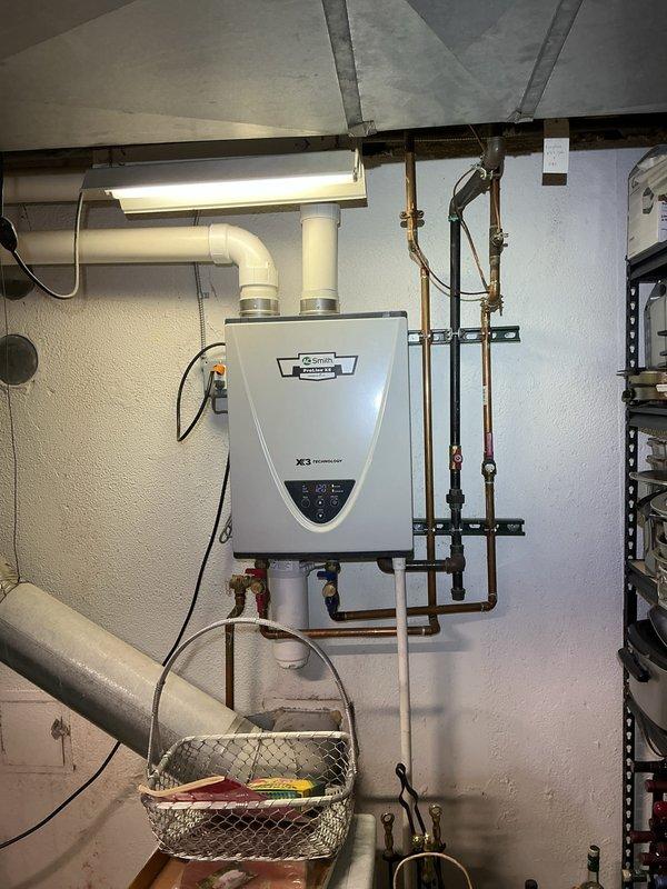 Completed comprehensive Gold AC inspection on single residential cooling system with air handler located in basement. Verified system operational status, documented thermostat functionality with Emerson digital control unit, and inspected basement mechanical room housing HVAC equipment. All components found operating within normal parameters, with equipment age under 10 years and system responding appropriately to thermostat commands.