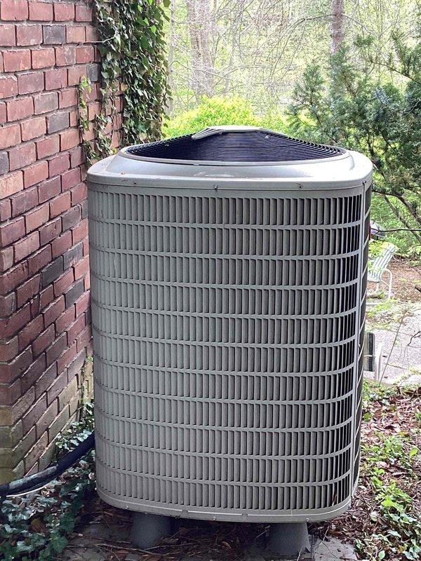Completed air conditioning system estimate for Bryant equipment replacement due to complete refrigerant loss in existing unit under 5 years old. Inspected outdoor condenser unit positioned on concrete pad adjacent to residential structure and assessed basement-located air handler and coil assembly. Evaluated existing refrigerant line configuration including new and old line sets, reviewed HVAC infrastructure and plumbing connections in mechanical space, and documented equipment condition through photographic inspection. Advised property owner regarding necessary clearance of debris and animal waste around condenser unit perimeter prior to installation, and provided weather-dependent scheduling parameters for replacement service requiring minimum 65-degree ambient temperature conditions for proper system commissioning.