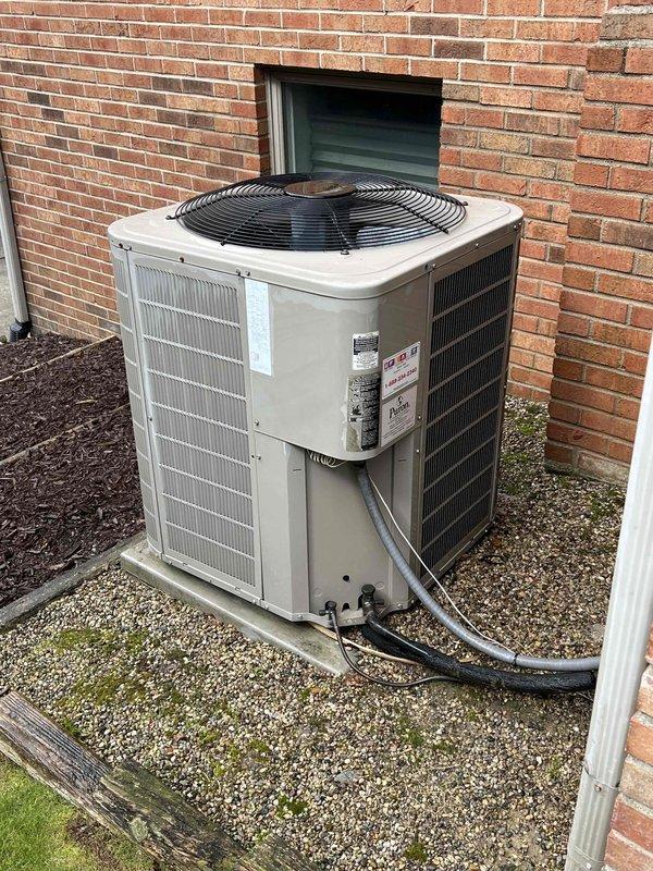 Completed comprehensive Gold AC inspection on 10-year-old residential air conditioning system with air handler located in basement. Performed thorough examination of outdoor condenser unit positioned on gravel pad, confirming proper operation of compressor, condenser fan motor, and electrical components including capacitor and contactor. Inspected refrigerant line connections, verified secure mounting, and assessed overall unit condition. Evaluated electrical wiring and connections within control panel, noting normal dust accumulation on components. Condenser coils showed minor dirt accumulation on exterior louvers but maintained adequate airflow. Unit operating within normal parameters with no immediate service concerns identified. System confirmed functional and ready for continued seasonal operation.