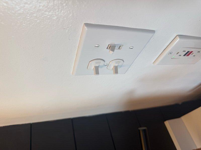 Responded to service call for non-functioning wall-mounted light fixture and GFCI outlet replacement. Diagnosed power issue at wall fixture and restored electrical service. Replaced multiple GFCI outlets with properly grounded units to meet current electrical code requirements. Verified all circuits functioning correctly, tested ground fault protection on new outlets, and confirmed three-fixture pendant lighting system operational in bathroom area. All work completed to code specifications with proper grounding throughout.