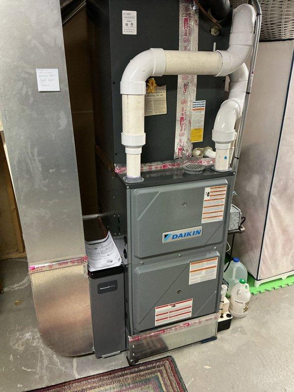 Completed preventative maintenance inspection on residential multi-zone HVAC system consisting of Daikin mini-split unit and conventional air conditioning system with furnace located in basement. Both systems are less than 10 years old and operational at time of service. Documented equipment condition through photography, verified proper operation of all components including condensate removal systems, inspected refrigerant lines and PVC drainage configuration, and confirmed all safety labels and warning stickers present on equipment.