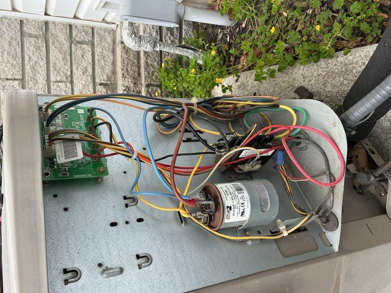 Completed comprehensive Gold AC inspection on 2006 residential air conditioning system with air handler located in basement. Performed thorough evaluation of outdoor condensing unit including inspection of compressor, capacitor, control board, and all electrical connections. Verified proper operation of all system components, examined wiring harness and PCB assembly, and documented equipment condition through photographic records showing control board, motor assembly, and unit identification markings.