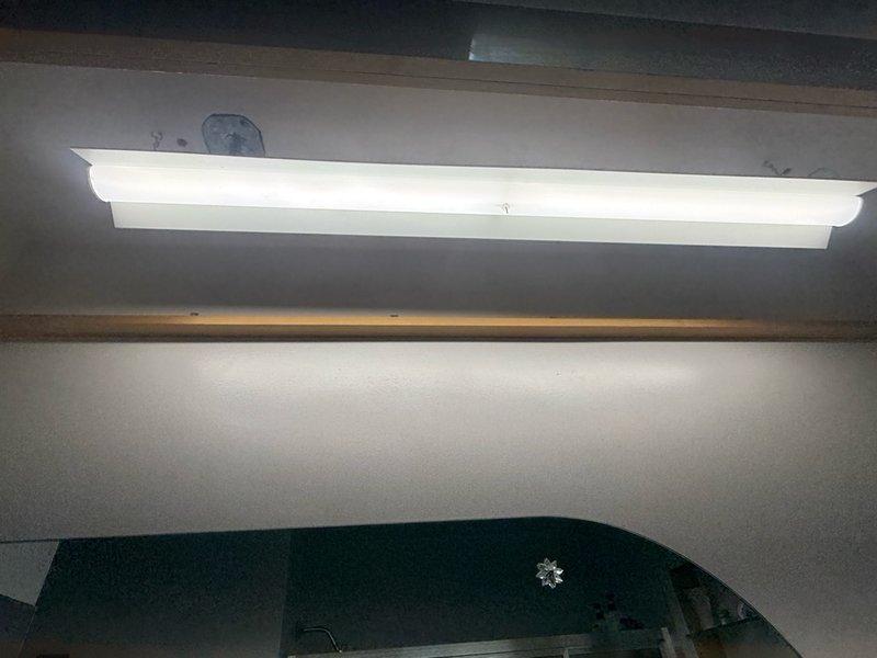 Completed installation of fluorescent light fixture in utility area ceiling space. Mounted fixture to junction box with proper securing hardware and verified electrical connections. Installed diffuser cover and tested operation to ensure proper illumination. All work performed to code specifications with clean professional finish.