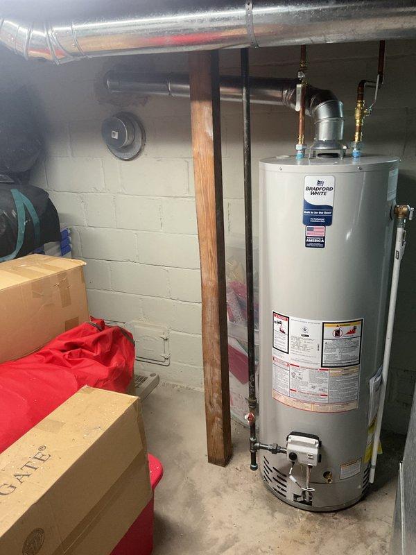 Returned to property to complete chimney liner installation for water heater that was previously installed under separate job number. Successfully installed metallic chimney liner system with proper venting connections, secured all ductwork with appropriate clamps and fasteners, and verified proper draft and ventilation for safe operation of the Bradford White water heater unit.