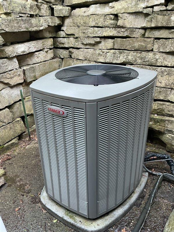 Completed comprehensive Gold AC inspection on 1-year-old Lennox outdoor condensing unit located at basement level. Performed thorough evaluation of condenser coils, refrigerant lines, electrical connections, and fan operation. Inspected thermostat functionality, humidifier operation, and hot water tank as part of complete system assessment. Unit found in excellent condition with proper airflow through louvers, secure refrigerant line connections, and clean condenser coils. Verified all components operating within manufacturer specifications with no deficiencies noted.