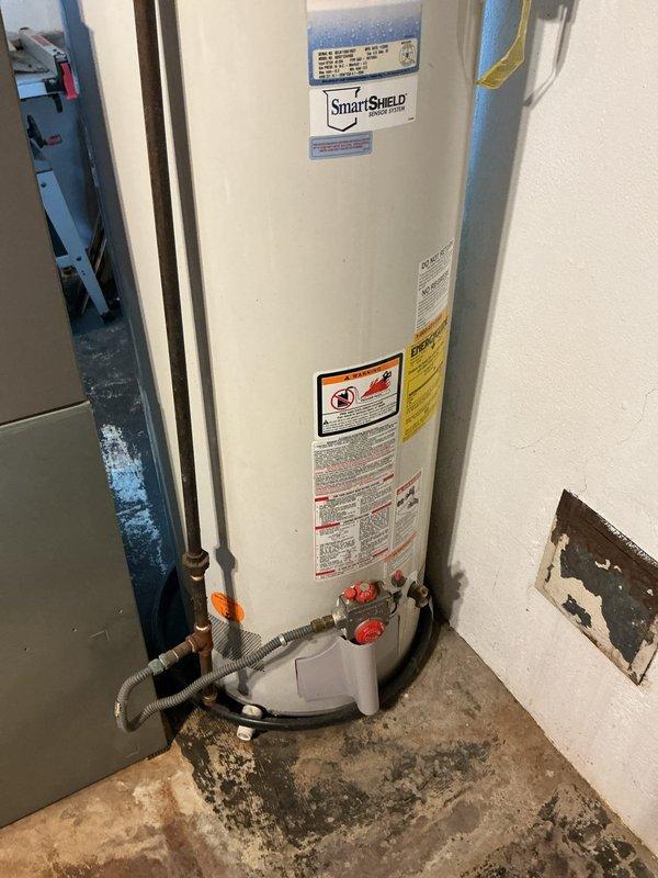 Completed installation of a 50-gallon GE SmartWater tanked water heater in basement utility room. Reconnected all water supply lines using copper piping with foam insulation, installed flexible connectors at base with shutoff valves, and properly vented unit through metal exhaust vent pipe connected to existing ductwork. All plumbing connections, pressure relief valve piping, and gas line hookups were completed to code specifications, with unit tested and verified operational.