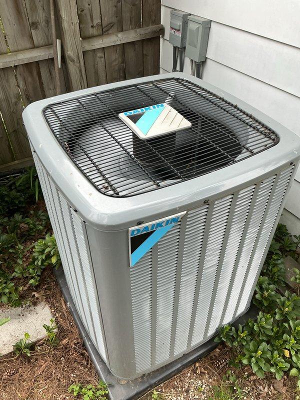 Completed comprehensive Gold AC inspection on 5-year-old Daikin condensing unit with air handler located on main floor near laundry area. Performed full system evaluation including visual inspection of outdoor condenser unit, verified operational status of fan assembly, checked electrical disconnect, and assessed overall equipment condition. Advised customer that vegetation and debris surrounding condenser base should be cleared for optimal airflow and efficiency, and recommended removing animal waste from area to prevent potential system damage and maintain proper operation.