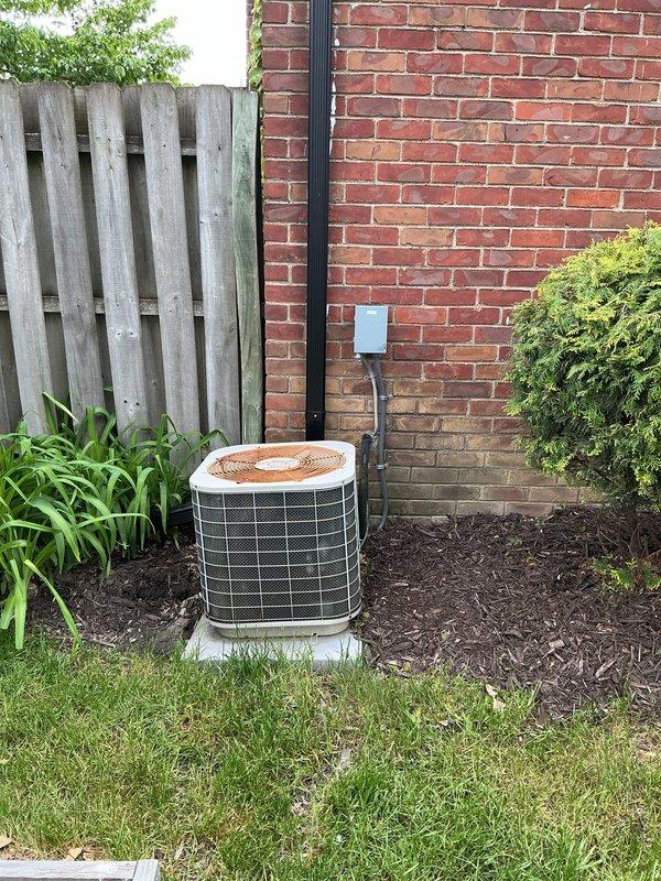 Completed AC tune-up on a 20-year-old air conditioning unit located on exterior concrete pad at rear of residence. System assessment revealed low R22 refrigerant levels, consistent with age and environmental regulations regarding phased-out refrigerants. Provided replacement estimate options for aging equipment given the unit's advanced age and diminishing availability of R22 refrigerant for future service needs.