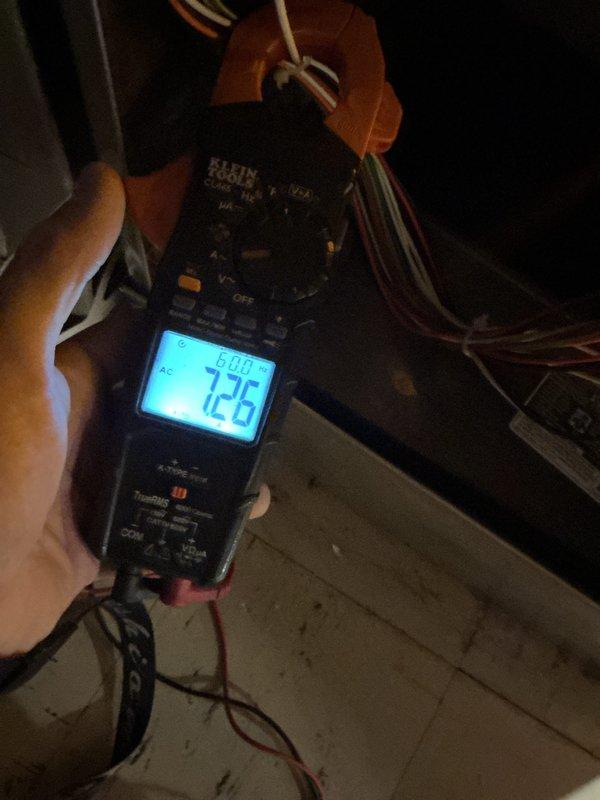 Completed comprehensive Gold AC inspection on 5-year-old single-unit residential HVAC system with equipment in working condition. Performed detailed system diagnostics including electrical testing with multimeter, recording voltage readings of 1296 to verify proper power supply to furnace and air handler assembly. Inspected indoor unit installation in basement utility area, confirming proper clearances, PVC condensate drain line connections, and flexible ductwork installation. Verified gas line connections, examined manufacturer specifications and safety labels, and assessed overall system operation. All components found functioning within normal parameters with no immediate service needs identified.