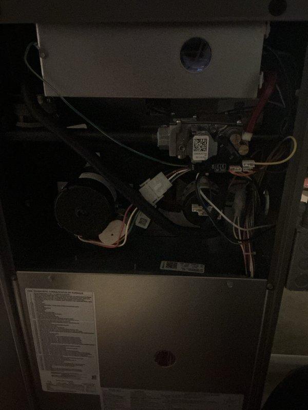 Completed comprehensive Gold AC Inspection on multi-unit residential HVAC system consisting of two furnaces and two air conditioning units located in basement. Both systems confirmed operational prior to inspection, with equipment ages of one year and three years respectively. Performed thorough examination of electrical components, wiring connections, control modules, and mechanical assemblies on both units. Inspected blower motor assemblies, capacitors, wire harnesses, and control boards for proper operation and secure connections. Verified all electrical terminations, safety controls, and manufacturer specifications. Documented internal components including QR-coded control modules and indicator lights showing normal system status. All units inspected and found to be functioning within normal parameters with no immediate service requirements identified.