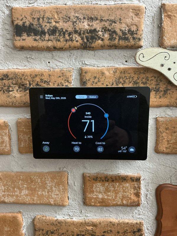 Completed comprehensive Gold AC inspection on single-unit Lennox system approximately one year old with air handler located in basement. System currently operational with thermostat set to heat at 70°F and cool at 82°F, displaying indoor temperature of 71°F with 39% humidity. Performed full visual inspection of furnace unit, air handler, PVC intake/exhaust venting, ductwork, and associated HVAC components in basement utility area. Verified proper operation of all equipment, checked connections, and documented system condition through photographic records. All components functioning within normal parameters at time of inspection.