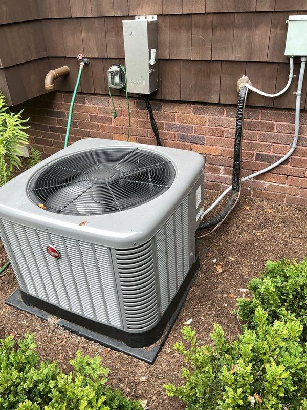 Completed comprehensive spring maintenance inspection on three residential air conditioning systems: one 1-year-old unit and two 15-year-old units located in basement and attic spaces. Performed Gold AC Tune-Up protocol on all three systems, including filter inspection, refrigerant level verification, electrical connection testing, condenser coil cleaning, fan motor lubrication, and thermostat calibration. All outdoor condensing units inspected and photographed, with older units showing normal wear consistent with 15 years of operation but maintaining operational integrity. Systems tested and confirmed operational for cooling season.