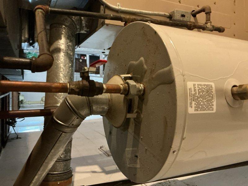 Responded to service call for no hot water and leaking 75-gallon tanked water heater approximately 8-10 years old. Upon inspection, confirmed active leak from tank and determined unit had reached end of serviceable life. Disconnected existing water heater, removed failed unit, and installed replacement 75-gallon residential water heater. Reconnected copper supply lines with brass fittings and shut-off valves, verified all connections for proper seal and operation, and tested system to ensure adequate hot water delivery throughout residence.