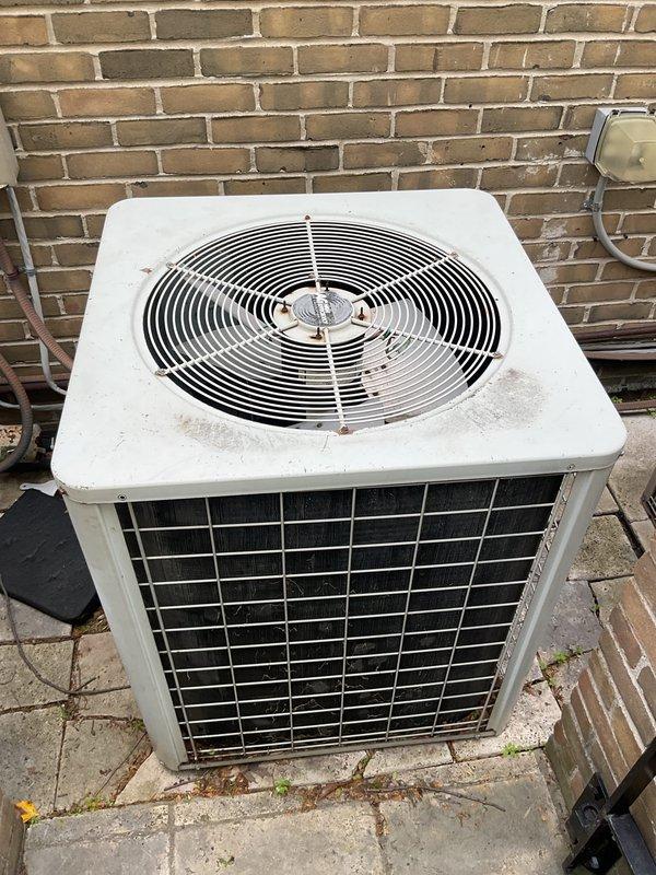 Completed comprehensive Gold AC inspection on single-unit residential air conditioning system with air handler located in basement. Performed thorough evaluation of outdoor condenser unit, indoor air handling components, and associated refrigerant lines and drainage systems. Inspected condenser unit positioned on exterior concrete pad, noting operational status of fan assembly and confirming proper electrical connections at disconnect box. Verified condensate drain line routing from basement air handler to exterior discharge point, documented as first-floor system installation. All equipment found in operational condition at time of inspection with no immediate service requirements identified.
