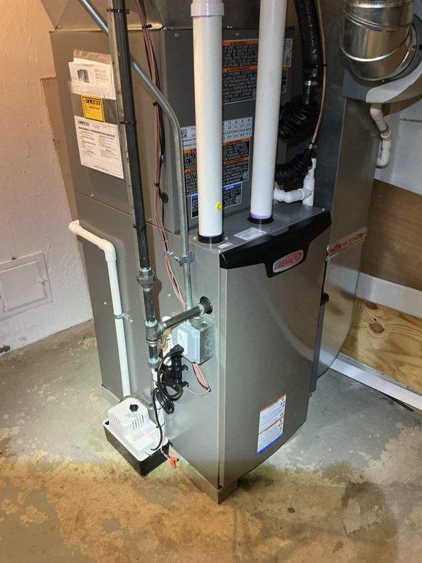 Responded to service call for dirty condensation pump on 1-year-old HVAC system located in basement. Upon inspection, found condensate pump requiring cleaning due to accumulated debris and buildup affecting proper drainage operation. Removed pump assembly, thoroughly cleaned internal components and discharge lines, verified proper operation and drainage flow. Inspected furnace unit and associated PVC intake/exhaust venting for proper installation and clearances. Tested system operation to ensure condensate removal functioning correctly. Unit returned to normal operating condition with proper condensate drainage restored.