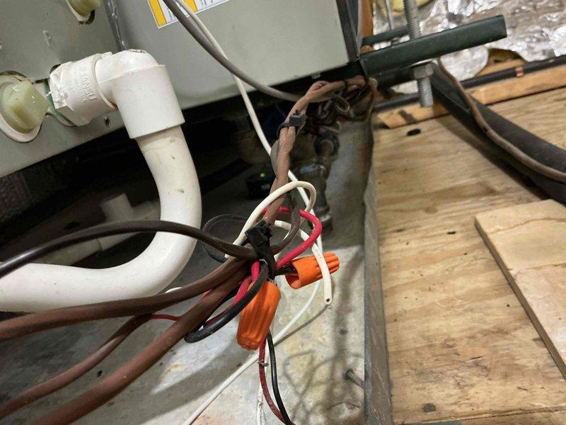Completed comprehensive preventive maintenance inspection on residential furnace and air conditioning system. Performed multi-point tune-up on equipment located in basement and attic areas, including inspection of evaporator coils which showed dust accumulation, verification of electrical connections with proper wire terminations and cable management, and assessment of condensate drain line routing. Checked all mechanical and electrical components, confirmed proper operation of both heating and cooling systems, and documented equipment condition with photographic records showing typical wear for units within the 1-10 year age range.