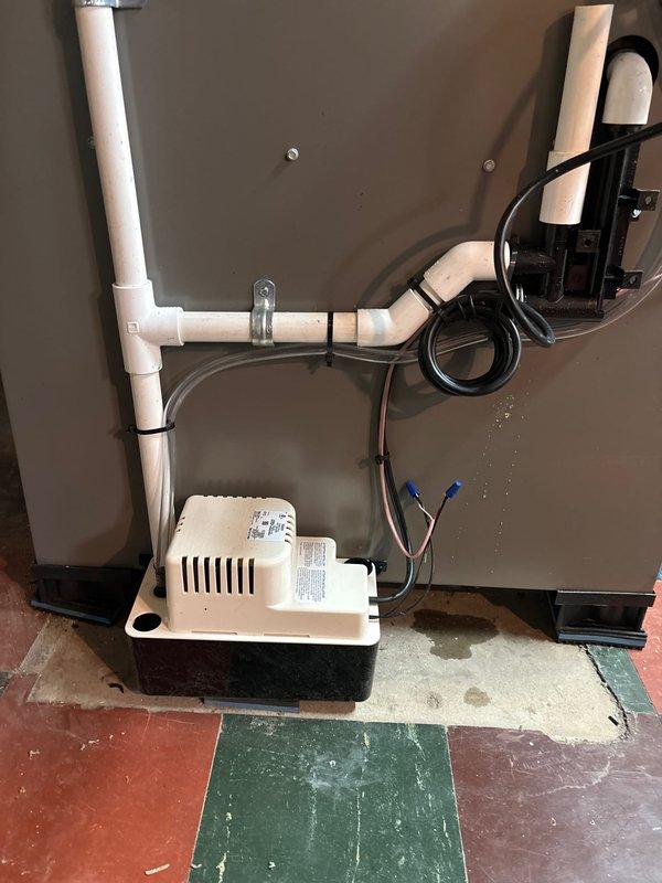 Completed full HVAC system installation including 70,000 BTU furnace with evaporator coil, 2.5-ton air conditioning unit, programmable thermostat, and humidifier. Installed condensate pump with PVC drainage piping to handle system condensate removal. Reconnected existing electrical service and completed all mechanical, electrical, and furnace permits as required. System registered with AHRI certificate 215663829 and qualifies for utility rebate program.