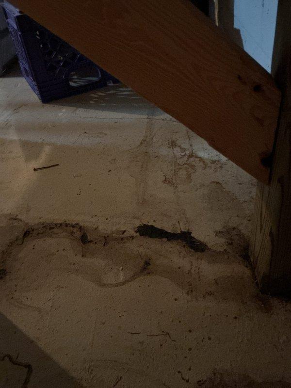 Responded to a drainage issue where utility company was unable to advance camera scope through the sewer line. Upon arrival, found evidence of sewage backup in basement area with significant contamination around floor drain and vertical drain pipe. Performed diagnostic assessment of the blockage preventing scope passage. Documented existing water damage and staining on basement floor surrounding plumbing fixtures, indicating previous or ongoing drainage problems requiring further investigation and remediation.