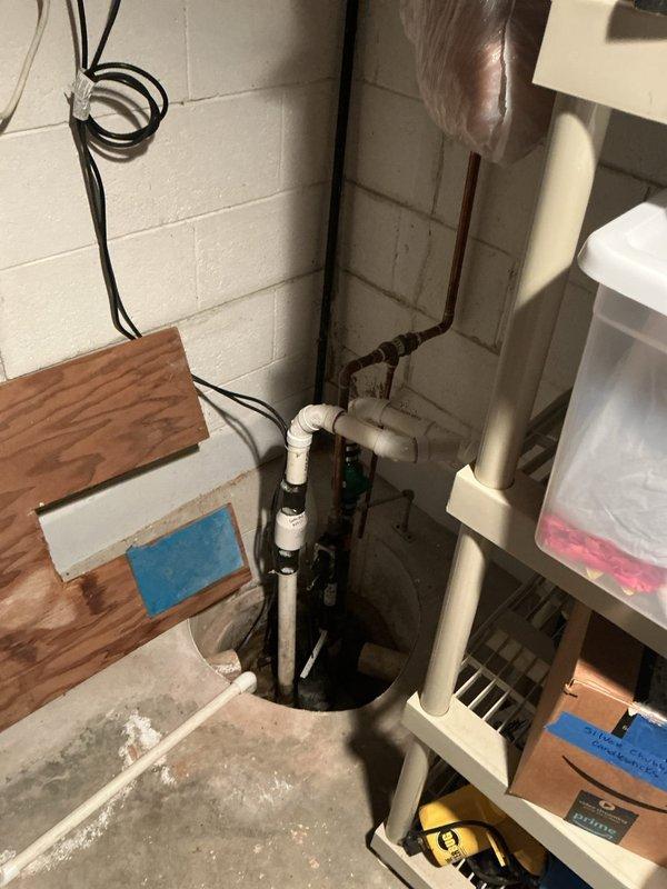 Responded to service call for sump pump evaluation and potential replacement in residential basement utility area. Upon arrival, performed comprehensive inspection of existing sump pump system, basin, and associated discharge piping. Assessed condition of pump operation, float mechanism, and electrical connections. Evaluated PVC discharge line configuration and backflow prevention components. Documented current system setup including basin condition, pipe connections, and overall plumbing infrastructure. Identified areas requiring attention and provided technical assessment for replacement recommendations. System photographed for reference and quote preparation purposes.