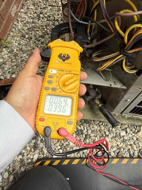 Completed comprehensive Gold AC inspection on 18-year-old residential air conditioning system with basement-located air handler and coil. Performed thorough examination of electrical components, control wiring, and terminal connections, documenting all findings with detailed photography. Utilized digital multimeter to verify electrical readings and test system performance parameters, confirming unit operational status and proper functionality of all components.