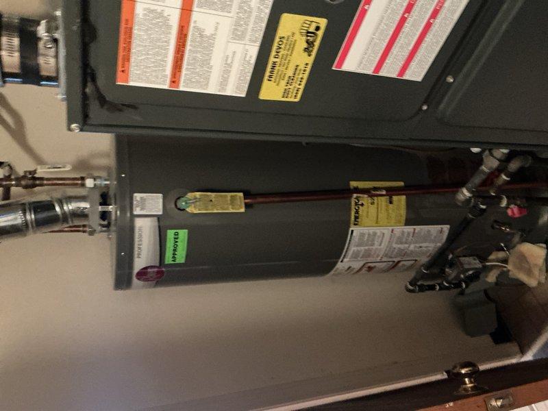 Responded to customer complaint of hammering noise from water heater at end of heating cycle. Inspected Rheem Professional series tanked water heater located in second-level utility room. Diagnosed water hammer condition caused by thermal expansion and rapid valve closure during heating cycle completion. Verified proper operation of temperature and pressure relief valve, inspected all copper supply and discharge connections for secure mounting, and checked for loose pipe straps that could amplify vibration noise. Documented equipment condition with photographs showing unit installation, piping configuration, and connection points. Recommended installation of water hammer arrestor on hot water supply line and thermal expansion tank on cold water inlet to eliminate noise and prevent future occurrences in this 35-year-old plumbing system.