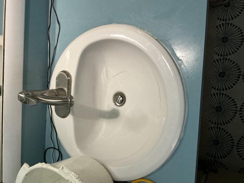 Responded to bathroom sink leak occurring during use at single vanity sink location. Upon inspection, identified compromised drain assembly and supply line connections beneath sink causing water seepage when fixture was operated. Disassembled existing drain trap configuration, replaced deteriorated washers and gaskets at connection points, and reinstalled PVC drain assembly with proper sealing. Tightened supply line fittings and verified all connections for proper seal integrity. Tested fixture under normal operating conditions to confirm leak elimination and proper drainage function.
