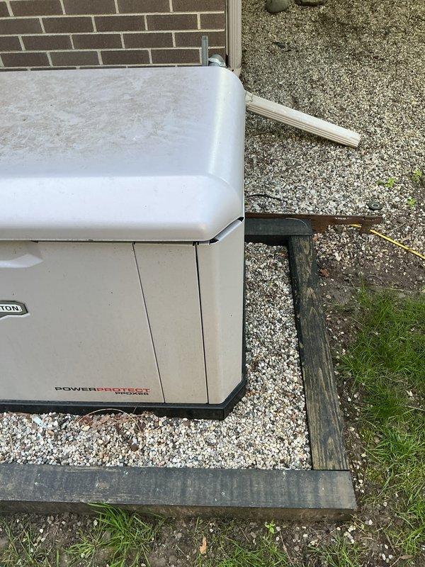 Responded to service call regarding residential backup generator with lid locking mechanism malfunction. Upon arrival, performed thorough inspection of generator enclosure panels and locking hardware to assess damage and determine cause. Examined top cover assembly, hinge points, and latch mechanism for signs of bending, misalignment, or structural compromise. Documented current condition of unit with photographs showing generator installation on gravel pad and close-up views of cabinet panels and hardware. Verified all fastening points and panel alignment. Investigation conducted to determine if issue resulted from previous maintenance visit or other external factors.