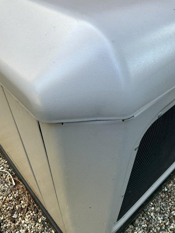 Responded to service call regarding residential backup generator with lid locking mechanism malfunction. Upon arrival, performed thorough inspection of generator enclosure panels and locking hardware to assess damage and determine cause. Examined top cover assembly, hinge points, and latch mechanism for signs of bending, misalignment, or structural compromise. Documented current condition of unit with photographs showing generator installation on gravel pad and close-up views of cabinet panels and hardware. Verified all fastening points and panel alignment. Investigation conducted to determine if issue resulted from previous maintenance visit or other external factors.