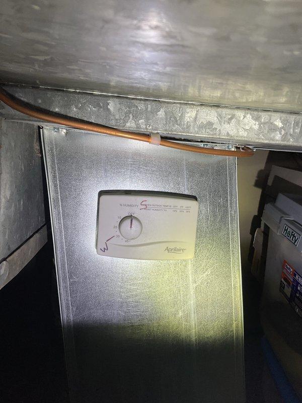 Completed comprehensive AC tune-up inspection on 3-year-old residential cooling system with basement-mounted air handler and outdoor condensing unit. Inspected Aprilaire humidity control system integrated with indoor equipment, verified proper operation of condenser unit with all components functioning normally, and confirmed adequate airflow through ductwork. System operating within manufacturer specifications with condenser area properly maintained and clear of debris obstruction.