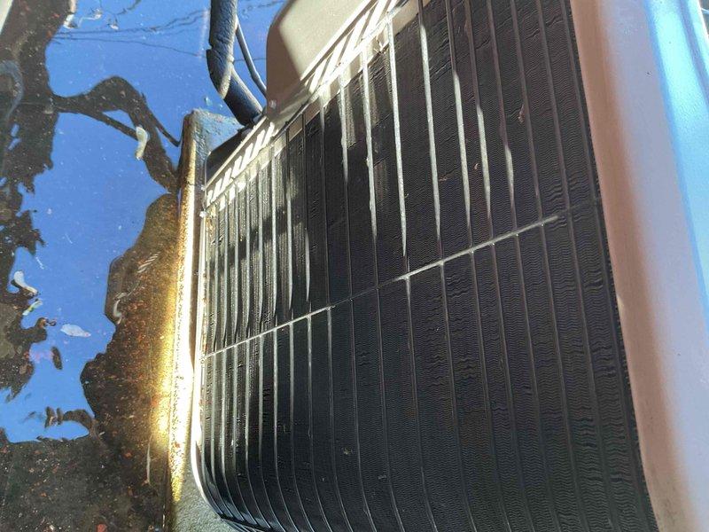 Completed comprehensive Gold AC inspection on 2024 model year outdoor condensing unit at single-family residence. System operational at time of service. Performed full visual inspection of exterior condensing unit, including examination of cabinet condition, condenser coil cleanliness, and refrigerant line insulation integrity. Noted minor debris accumulation around unit base and light dust buildup on condenser fins, typical for outdoor installation. All components functioning within normal parameters with no immediate service needs identified.