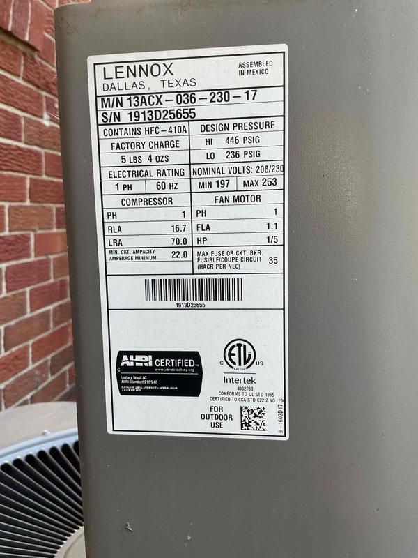 Completed comprehensive Gold AC inspection on a 10+ year old Lennox 13ACX-036-230-17 outdoor condensing unit utilizing HFC-410A refrigerant. Unit was operational upon arrival with system located at outdoor/basement configuration. Performed thorough visual assessment of condenser exterior housing, verified fan grille condition and proper mounting, inspected refrigerant line sets and electrical conduit connections. Confirmed manufacturer specifications including 208/230V electrical supply, design pressures of 446 PSIG high side and 236 PSIG low side, factory refrigerant charge of 5 lbs 4 oz, compressor RLA of 16.7 and condenser fan motor specifications of 1/5 HP. Documented unit serial number 1913D25655 and overall equipment condition showing typical outdoor weathering with functional operation maintained throughout inspection.