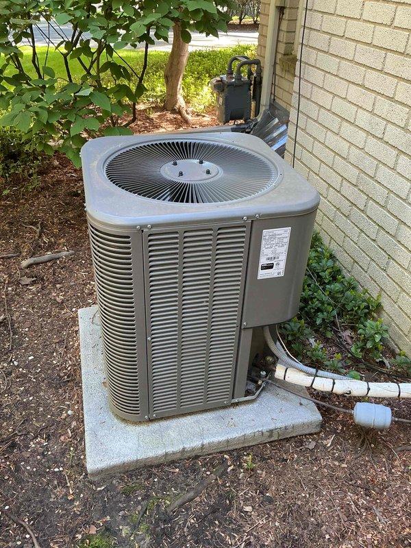 Completed comprehensive Gold AC inspection on multi-unit residential HVAC system with equipment under 10 years old. Performed full system evaluation of outdoor condensing unit and basement-located air handler, verifying operational status, refrigerant levels, electrical connections, and airflow performance. Documented equipment condition with photos showing condenser unit properly positioned on concrete pad with adequate clearance, confirmed system operating within normal parameters, and verified all components functioning correctly with no service issues identified.