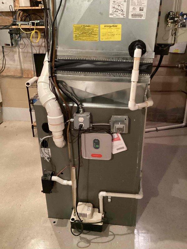 Conducted comprehensive HVAC system evaluation for air conditioning replacement estimate at residential property with failed outdoor fan motor and R22 refrigerant system. Inspected existing basement-located furnace and air handler configuration, documented current equipment specifications including Lennox unit with associated ductwork, PVC condensate drainage, humidifier controls, and return air setup. Provided homeowner with replacement options and technical recommendations for upgrading from obsolete R22 system to modern, efficient equipment.