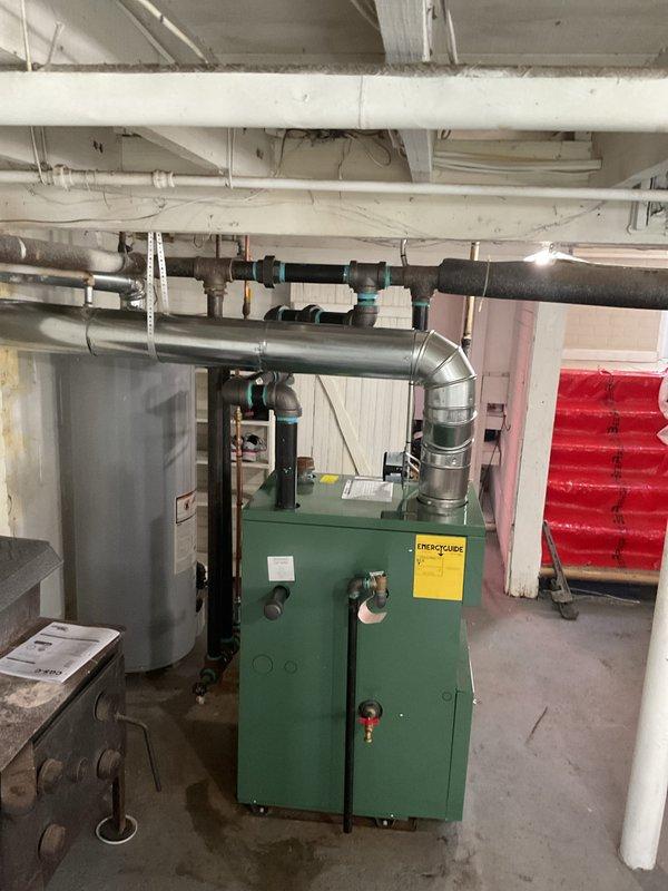 Completed residential steam boiler installation in basement mechanical room, including new green heating unit with metal exhaust vent system and proper venting configuration. Installed new thermostat, three (3) steam vents, and 1.25" angle radiator valve to optimize system performance and control. Secured all required permits for mechanical, electrical, boiler installation, and reconnection work, ensuring full code compliance for the heating system upgrade.