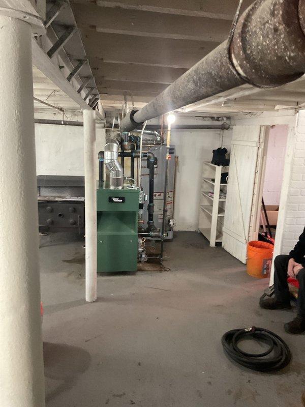 Completed residential steam boiler installation in basement mechanical room, including new green heating unit with metal exhaust vent system and proper venting configuration. Installed new thermostat, three (3) steam vents, and 1.25" angle radiator valve to optimize system performance and control. Secured all required permits for mechanical, electrical, boiler installation, and reconnection work, ensuring full code compliance for the heating system upgrade.