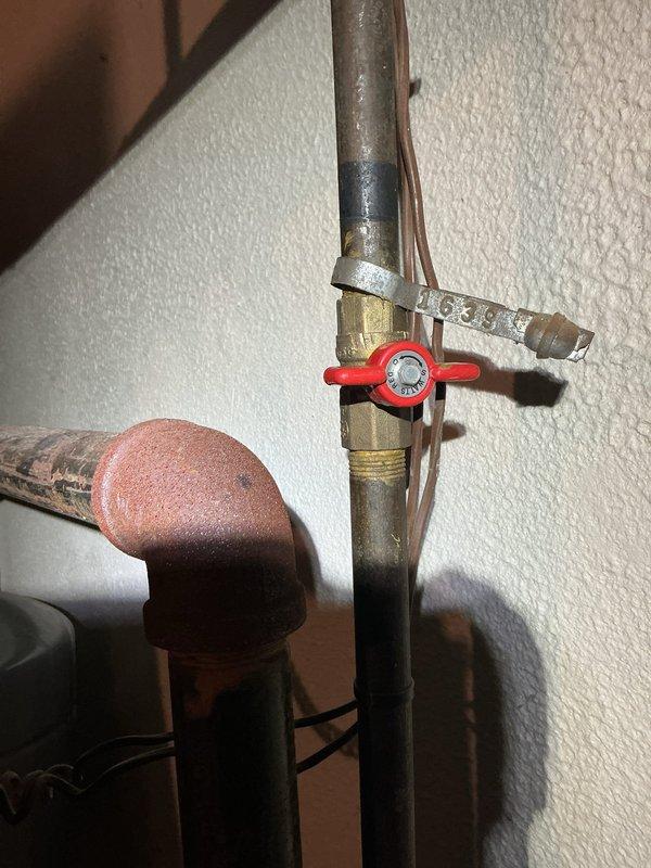 Responded to no heat call for 20+ year old boiler that failed after basement water backup caused equipment to become submerged. Upon inspection, found extensive water damage and corrosion to gas valve assembly, controls, and ductwork. Yellow gas valve showed rust contamination and electrical connections were compromised by moisture exposure. Advised customer that boiler sustained significant water damage rendering unit unsafe for operation and beyond economical repair given age and extent of corrosion. Recommended complete boiler replacement due to safety concerns with gas controls and electrical components after water intrusion. Unit was shut down and tagged out of service.