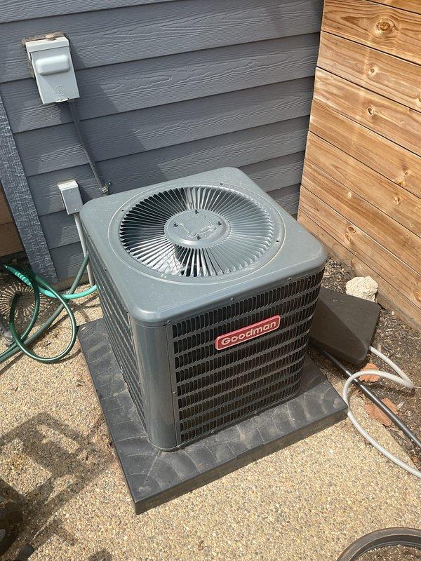 # HVAC Maintenance - Gold AC Inspection

Performed comprehensive Gold AC inspection on a non-operational 4-year-old Goodman air conditioning system with air handler located in basement. Upon arrival, confirmed equipment was not functioning properly and conducted thorough assessment of both indoor and outdoor components.

Inspected outdoor condensing unit positioned on concrete pad with proper clearances and mounting. Unit showed appropriate installation with electrical disconnect and service boxes properly positioned on exterior wall. Verified refrigerant line connections and electrical conduit routing to building penetration. Examined condenser coil louvers, fan guard assembly, and overall cabinet condition for any signs of damage or deterioration.

Proceeded to indoor air handler location in basement for inspection of filtration system and internal components. Discovered air filter with significant contamination including general dirt accumulation and notable yellow-green discolorati