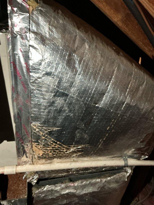 Completed estimate for air conditioning system replacement in attic location. Existing 10+ year old unit is non-operational and requires full replacement. Documented extensively damaged ductwork insulation with multiple tears, separations, and deteriorated foil facing throughout visible sections, along with existing electrical components and control units mounted on attic structural beams. Natural gas furnace remains in place with AC replacement recommended.