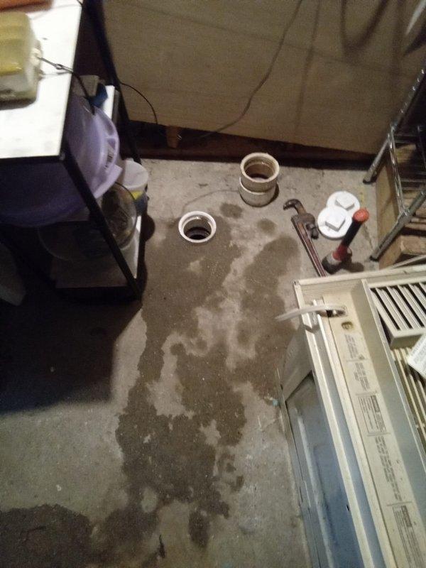 Performed camera inspection of main drain line to verify previous contractor's findings of sand material on snake cable. Inspection confirmed presence of sand and debris in drain line, indicating potential pipe deterioration or soil infiltration. Customer provided documentation and photos showing active work area with exposed plumbing components, floor staining consistent with water damage, and disassembled drain fittings for access point preparation.