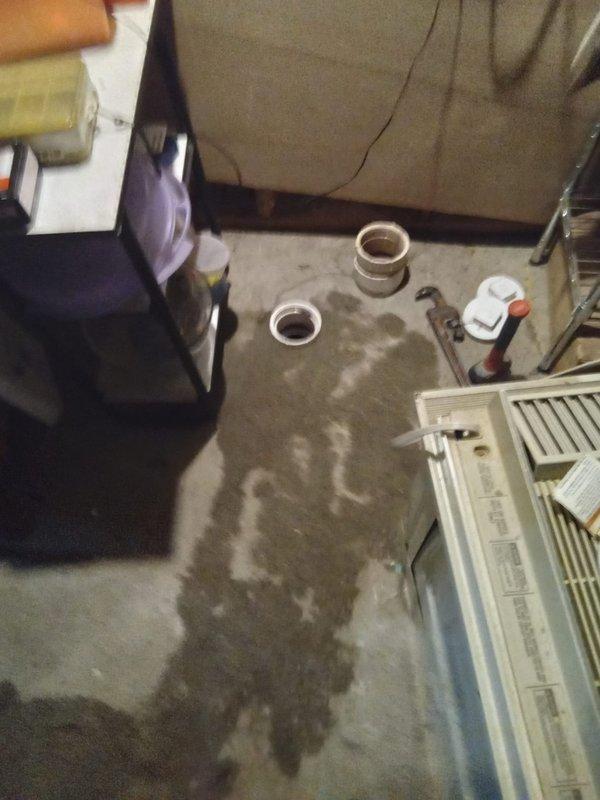 Performed camera inspection of main drain line to verify previous contractor's findings of sand material on snake cable. Inspection confirmed presence of sand and debris in drain line, indicating potential pipe deterioration or soil infiltration. Customer provided documentation and photos showing active work area with exposed plumbing components, floor staining consistent with water damage, and disassembled drain fittings for access point preparation.