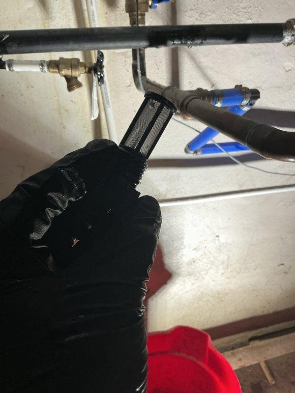 Responded to service call for tankless water heater displaying error code and failing to supply hot water throughout residence. Upon arrival, conducted diagnostic assessment of wall-mounted Energy Star certified unit in basement mechanical room. Inspected all water supply connections, gas lines, and electrical components. Tested system pressure and flow rates using calibration equipment to identify performance issues affecting hot water delivery. Examined PVC venting system, copper supply lines, and isolation valves for proper operation. Cleared error code from control panel and verified all connections at brass fittings and PEX distribution lines. Confirmed proper function of unit after troubleshooting, restoring hot water service to all fixtures throughout the home.